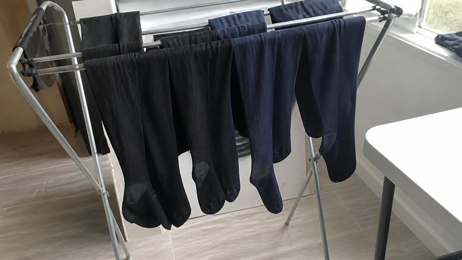 Compression socks air drying on a folding rack